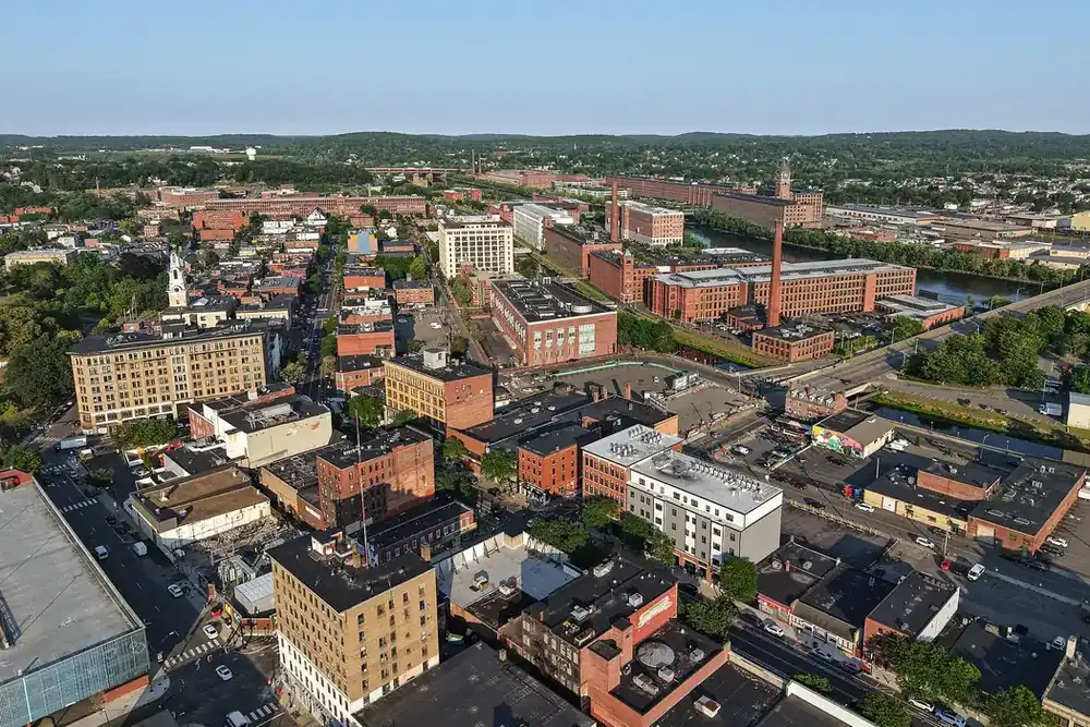 Aerial view of downtown Lawrence, Massachusetts, with brick mill buildings and city streets